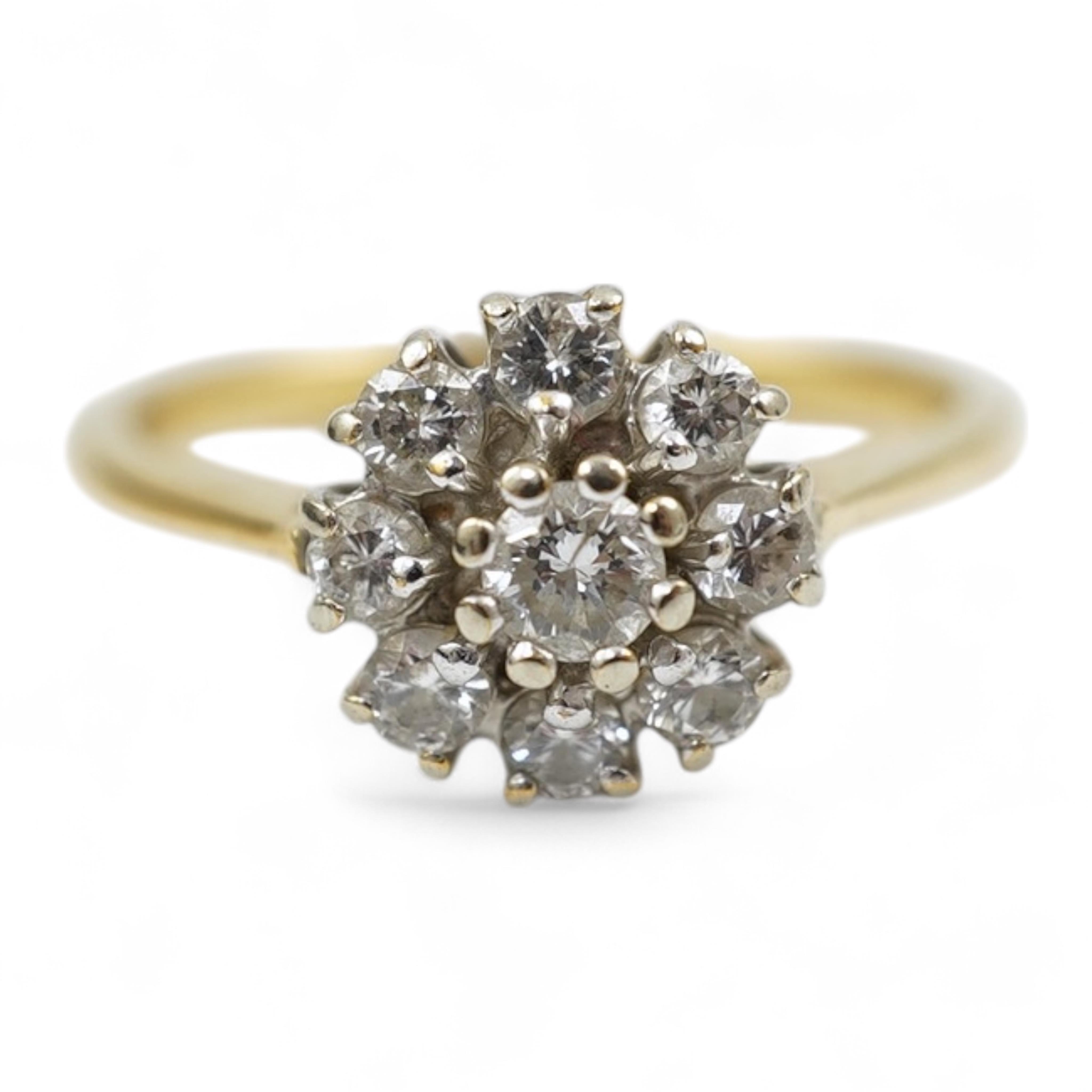 A modern 18ct gold and diamond set circular cluster ring, size M, gross weight 3.2 grams.